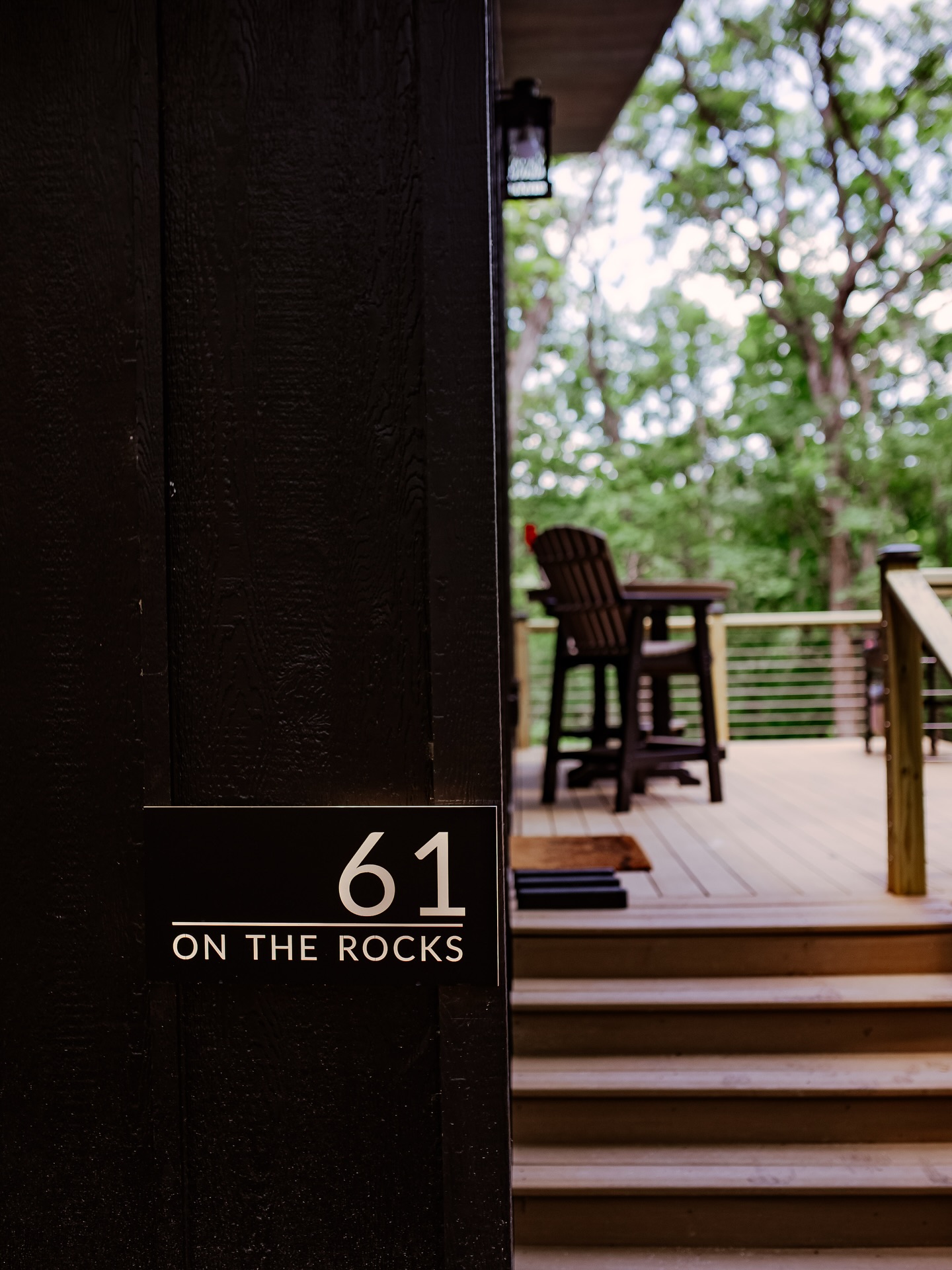 61 on the Rocks entrance with wooden deck and Adirondack chairs