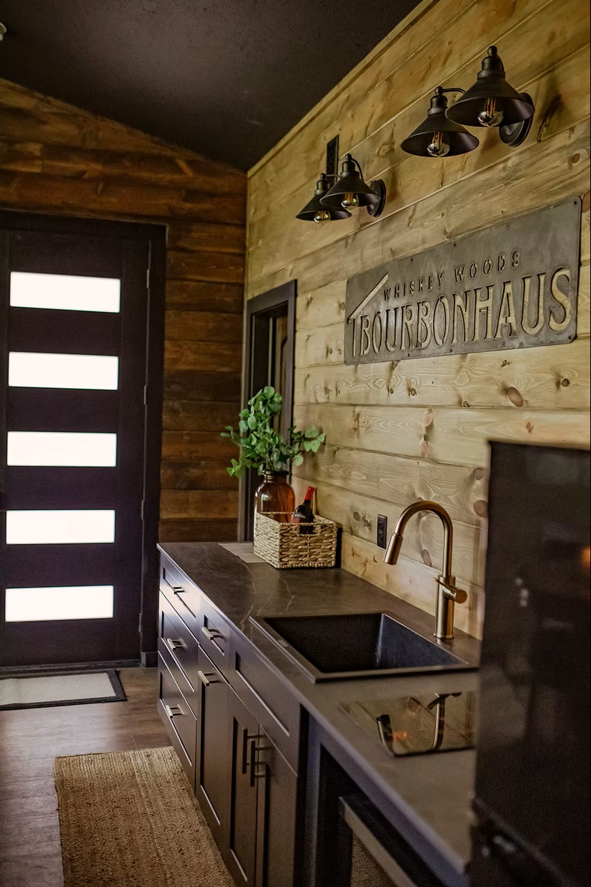Rustic whiskey-themed bar area with wooden walls and industrial lighting